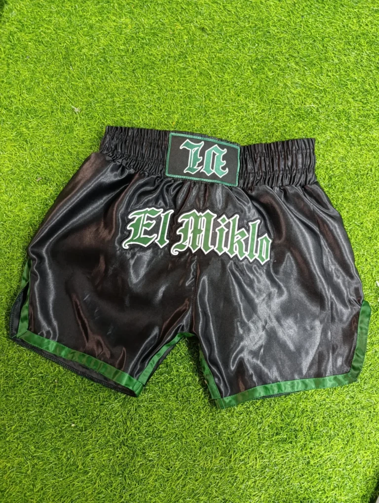 Black and green custom Muay Thai shorts with embroidery – made by Naxon Sports