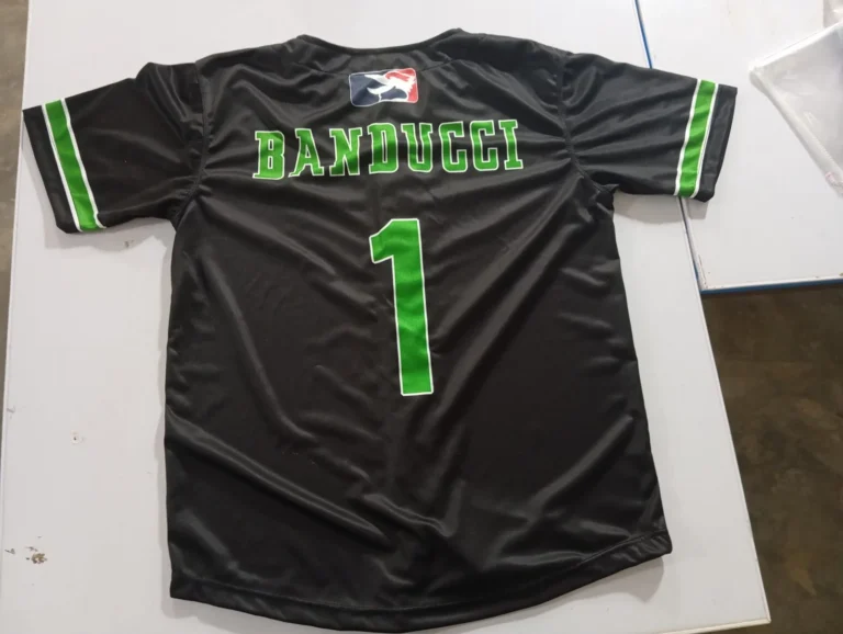 Custom black baseball jersey with green lettering and number – made by Naxon Sports