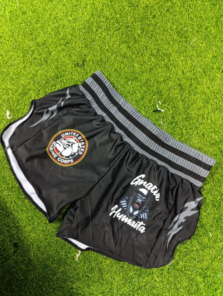 Custom black fight shorts with logo and contrast trim – made by Naxon Sports