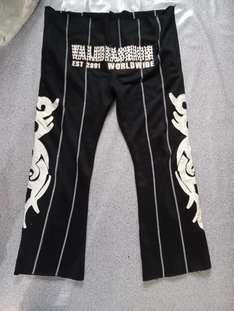 Custom black flare pants with tribal print and side stripes – made by Naxon Sports