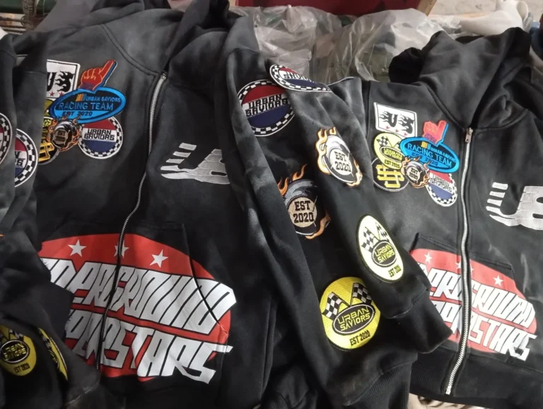 Custom black racing jackets with sewn patches – made by Naxon Sports