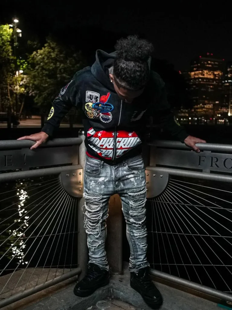 Custom black racing-style jacket with patches, client photoshoot – made by Naxon Sports