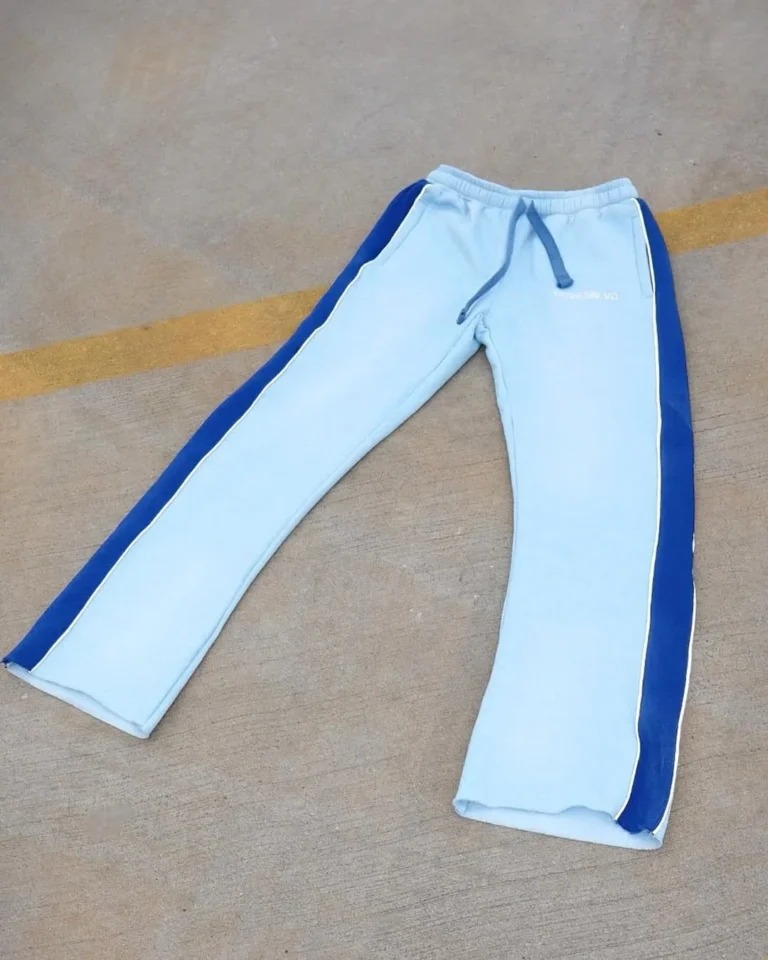 Custom light blue sweatpants with side stripe, flat lay – made by Naxon Sports