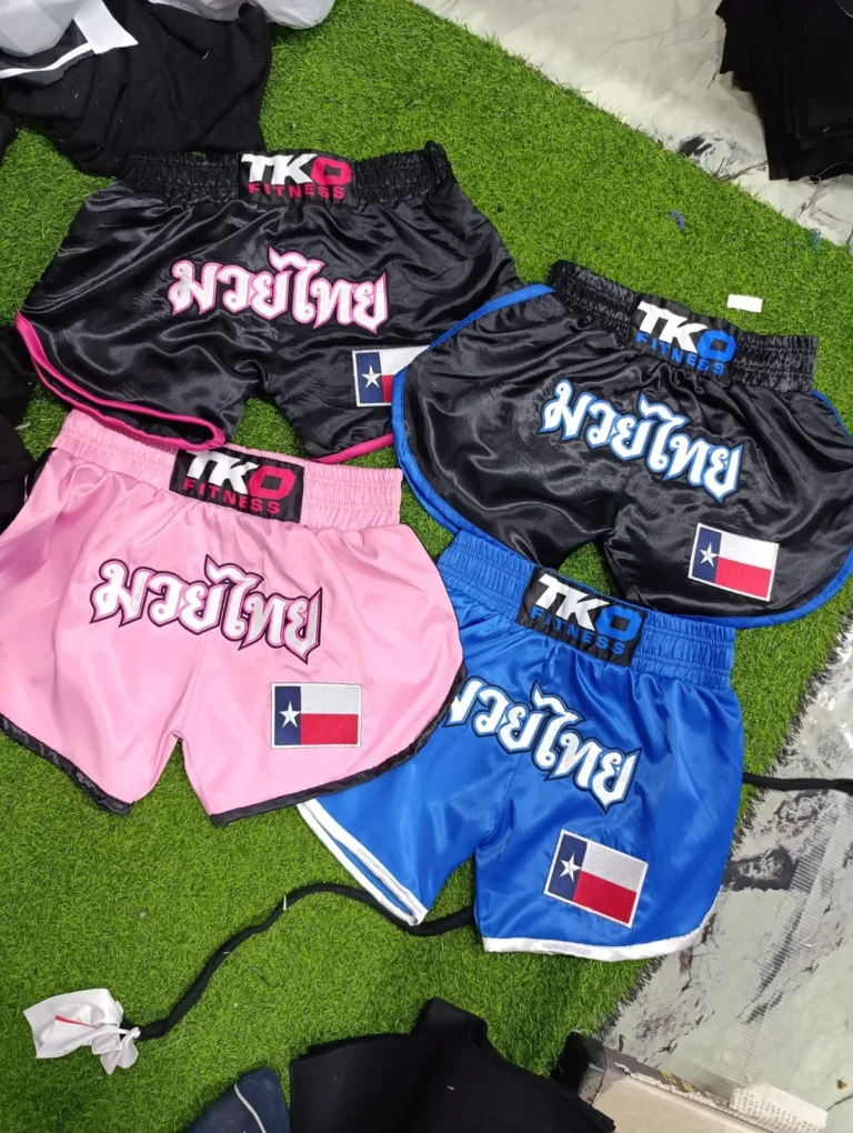 Custom Muay Thai shorts in pink, blue and black – made by Naxon Sports