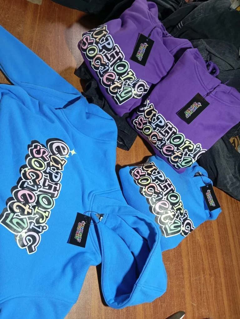Custom printed shirts in blue and purple from a bulk order – made by Naxon Sports