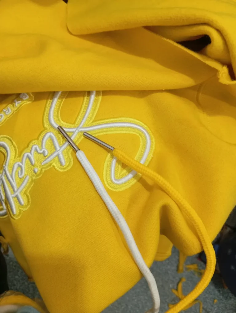 Custom yellow hoodie with script embroidery – made by Naxon Sports