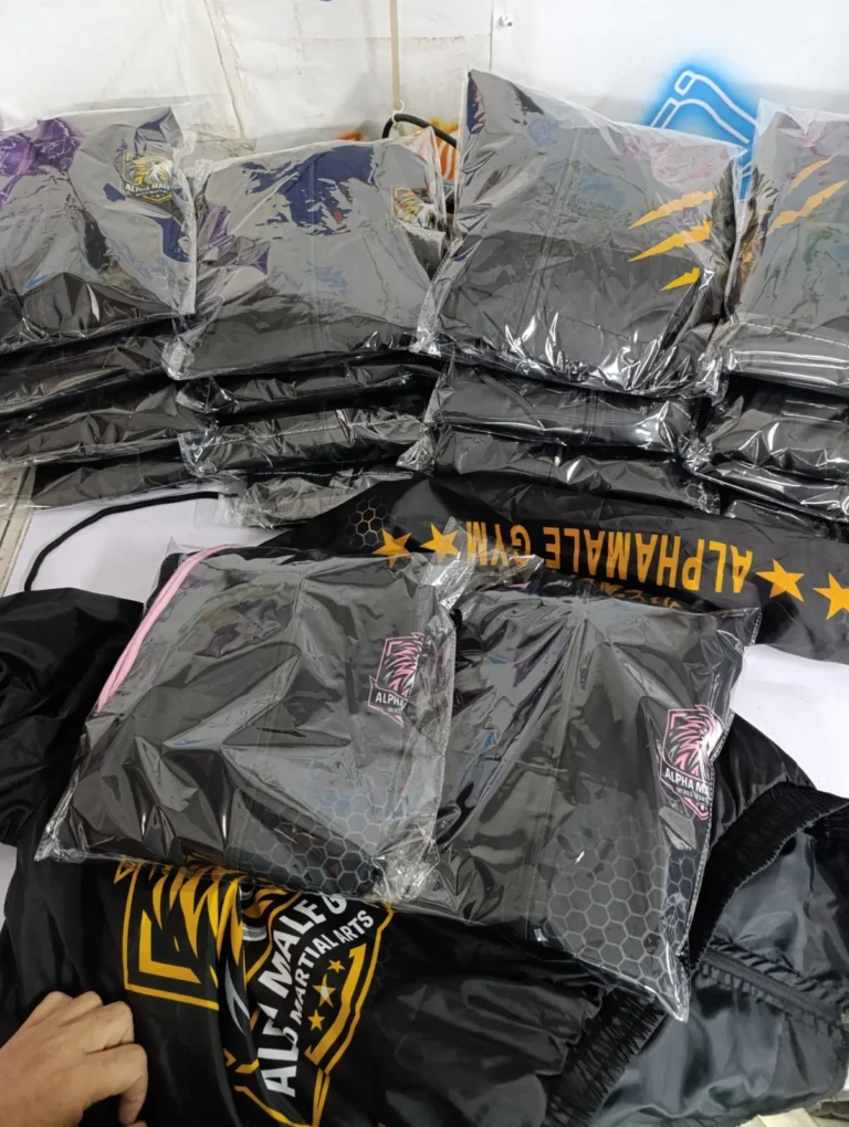 Finished custom garments stacked and packed for shipping – made by Naxon Sports