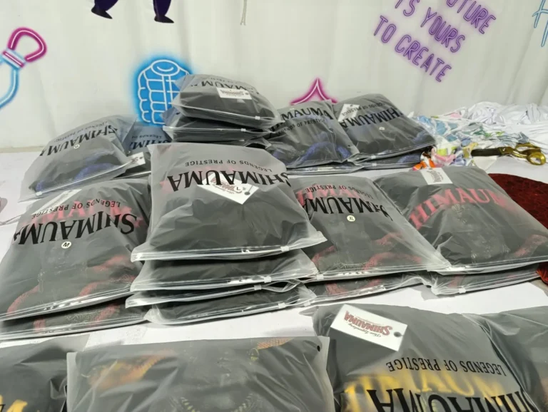 Folded custom printed t-shirts ready for packing – made by Naxon Sports