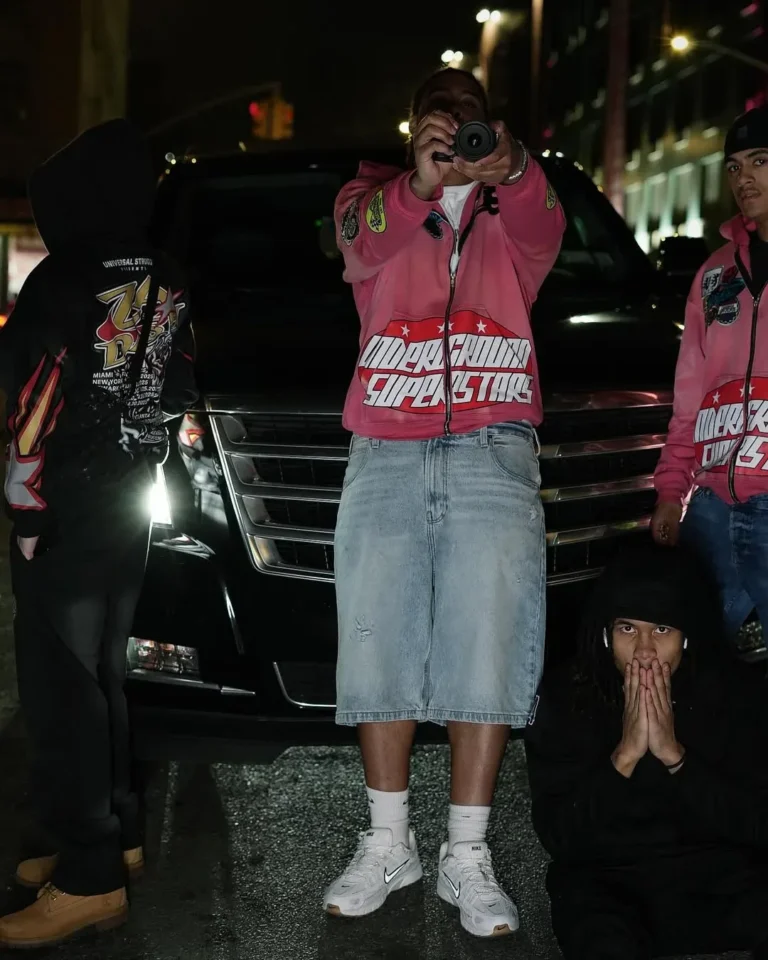 Group wearing custom pink racing jackets and denim shorts – made by Naxon Sports
