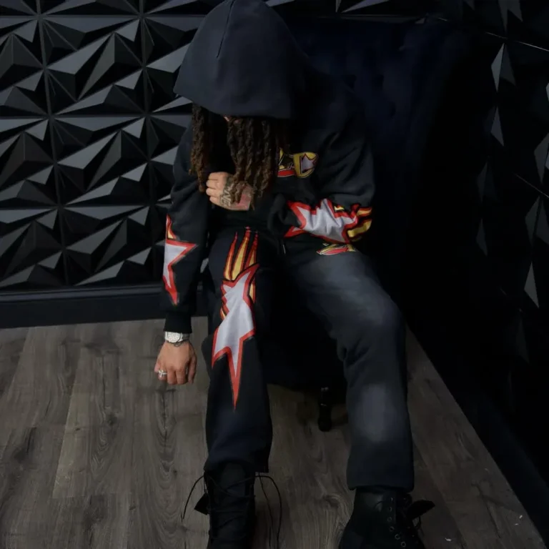 Model in custom black hoodie and pants with flame print – made by Naxon Sports