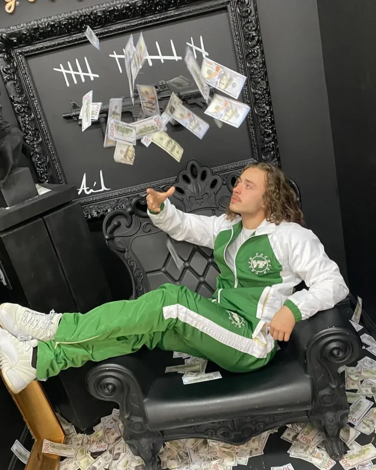 Model seated in a custom green and white tracksuit – made by Naxon Sports