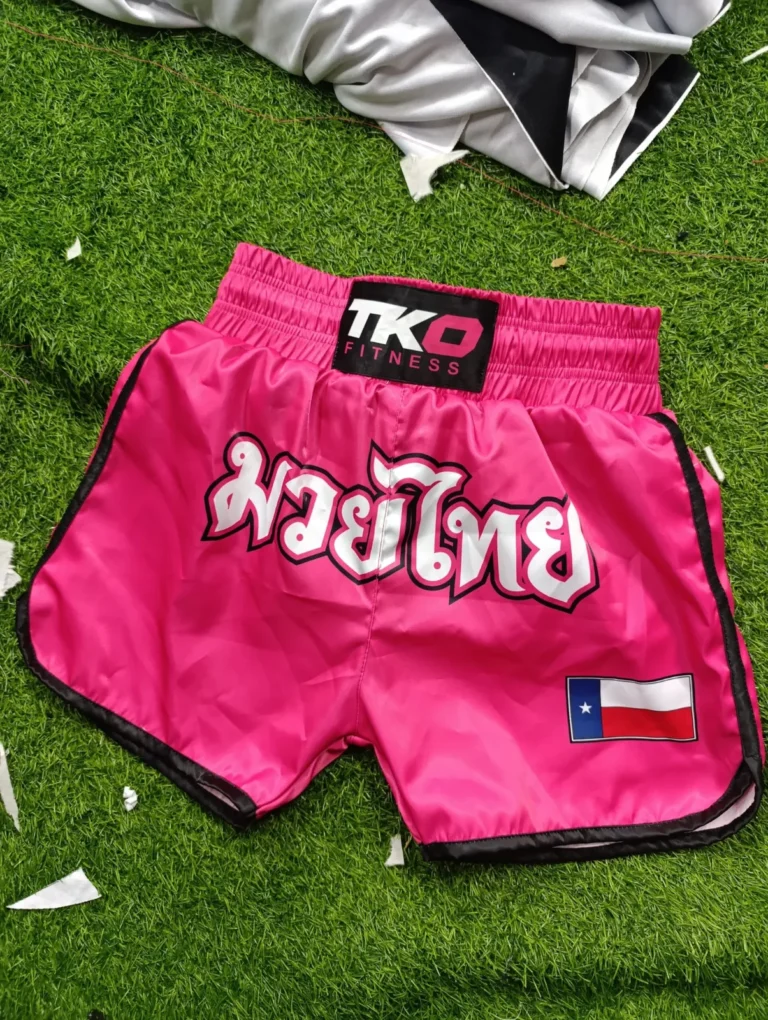 Pink custom satin Muay Thai shorts with lettering – made by Naxon Sports